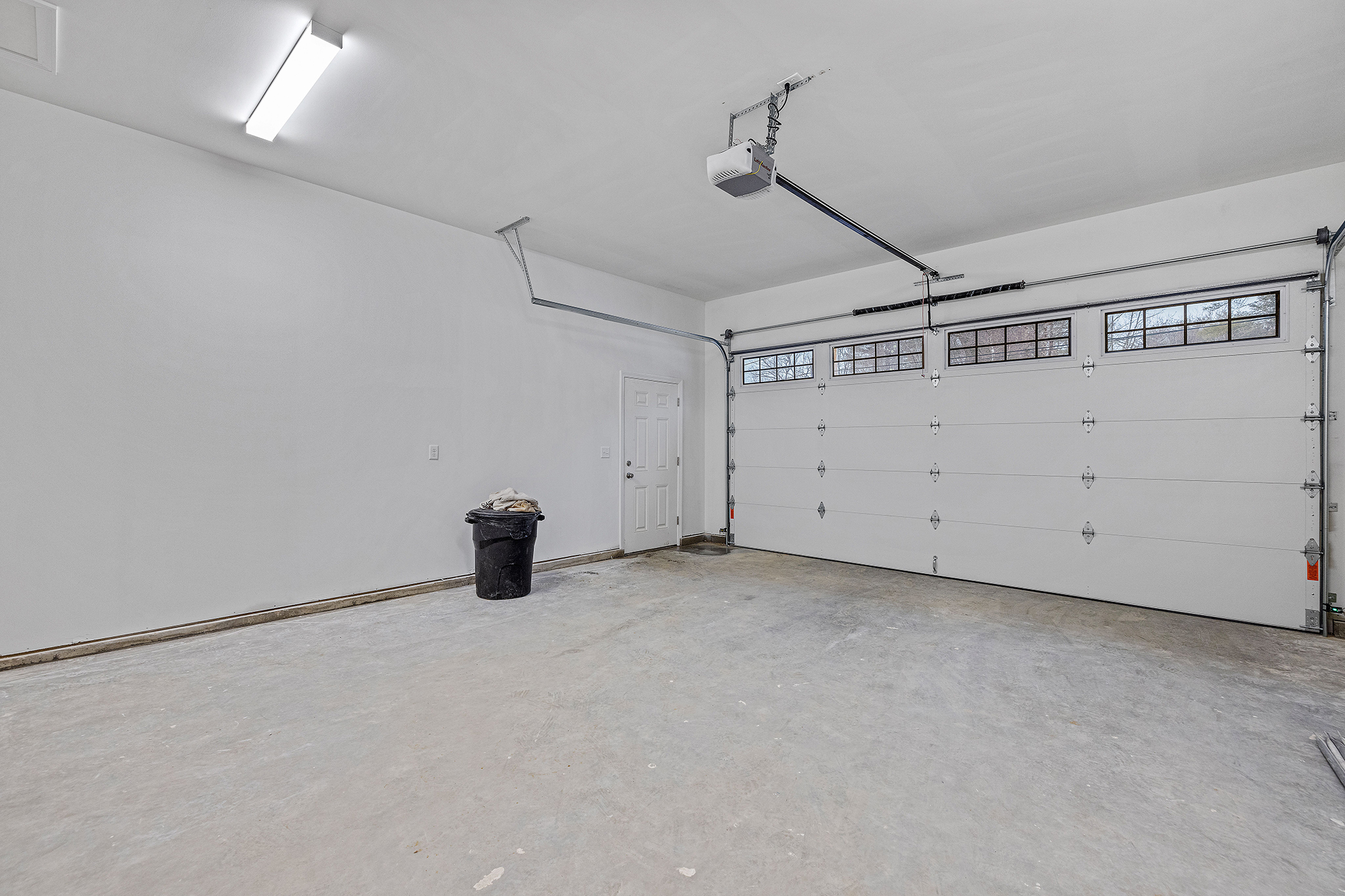 An empty white garage with windows